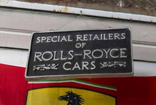 ROLLS ROYCE: A heavy cast aluminum double sided 'Special Retailers of Rolls-Royce Cars' sign with raised lettering, black background, 38cm high,&nbsp;65cm wide