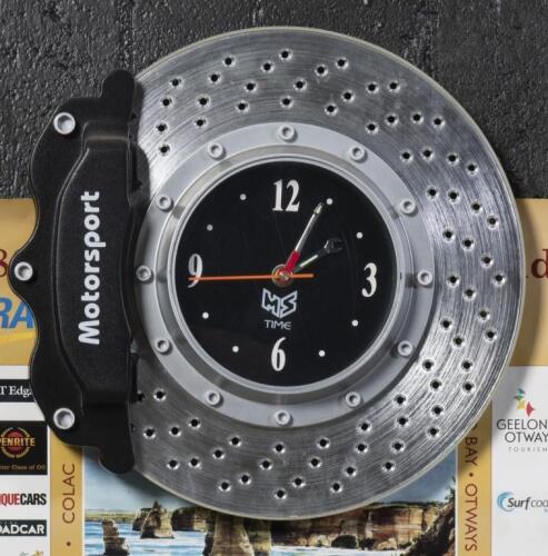 CLOCK: A modern plastic 'MS Time' clock in the form of a brake rotor & caliper, approx 33cm high, 35cm wide