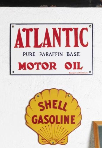SIGNS: Two modern reproduction enamel signs comprising an&nbsp;'Atlantic - Pure Parafin Base Motor Oil' sign and a&nbsp;'Shell Gasoline' sign,&nbsp;largest being Atlantic measures 27cm high, 43.5cm wide.&nbsp;