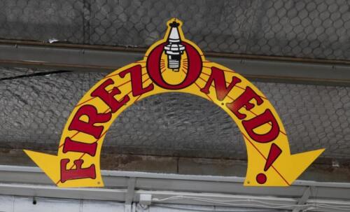 FIREZONE: A reproduction&nbsp;'Firezoned!' wreath sign as used on 1930s period petrol pumps, double side, 59cm high, 93cm wide approx