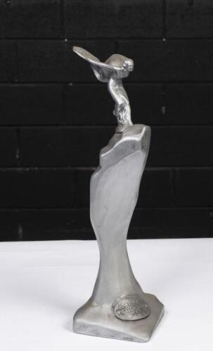 ROLLS-ROYCE: A ceramic replica of the Rolls-Royce 'Spirit of Ecstasy' mascot, elevated on base with label at bottom 'Rolls-Royce London L. Derby', 45cm high