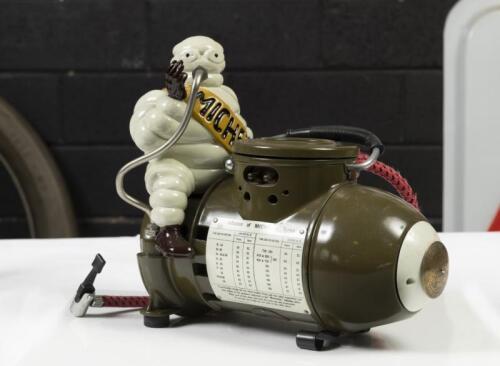 MICHELIN: A c1920s/1930s French Bibendum figural portable compressor produced Toussaint & Cie, France, restored for David by Peter Vandersluys with Bibendum figure printed to face of gauge, 27cm high, 28cm long