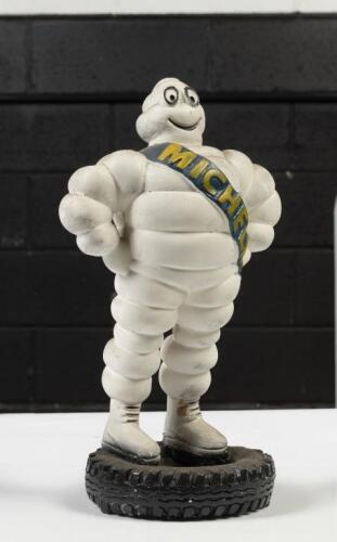 MICHELIN; A Michelin Bibendum man statue standing on a tyre, possibly plaster, 34cm in height&nbsp;