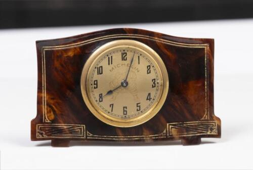 MICHELIN: A fine c1920s Michelin Tortoiseshell travel clock, gold face and bezel with Bibendum figure in centre, 6cm high, 11cm wide