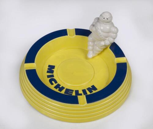 MICHELIN: A Michelin ceramic ash tray with Bibendum figure sitting on side, 16cm wide