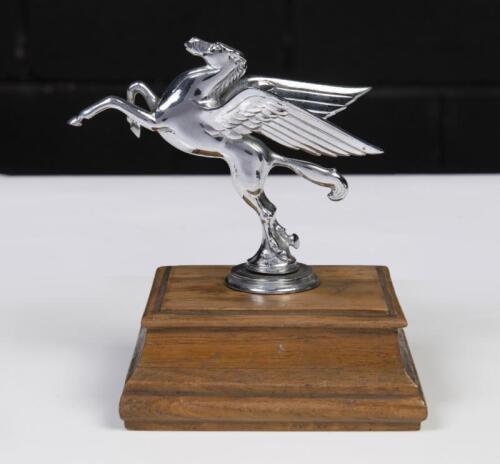 MOBIL: A fine Mobil Pegasus chrome emblem fitted to wooden base, 15cm high to base