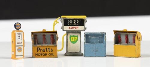 GARAGE MINIATURES: A group of five toy garage miniatures,comprising&nbsp;two petrol pumps and three highboy breadbins.
