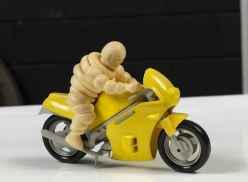 MICHELIN: A modern Michelin promotional item, features Bibendum riding a yellow motorcycle, 15cm long
