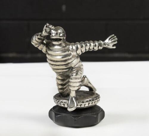 MICHELIN: An reproduction solid metal Michelin Bibendum&nbsp;figure advertising mascot in half kneel pose standing on a plastic cap base, 14cm high overall