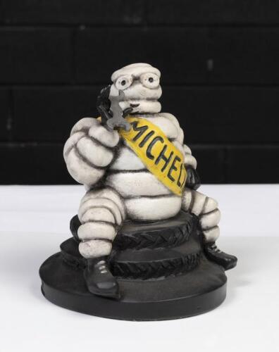 MICHELIN: A reproduced Michelin Bibendum figure sitting on tyres holding spanner in hand, 20cm high