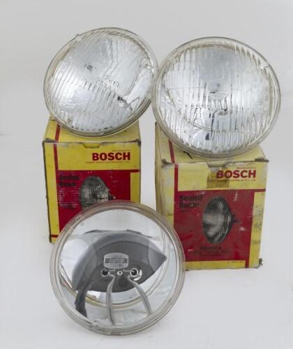 SEALED BEAM HEADLIGHTS: A group of three sealed beam headlights, one Koito branded and two Stanley branded in Bosch boxes, 14cm wide lens