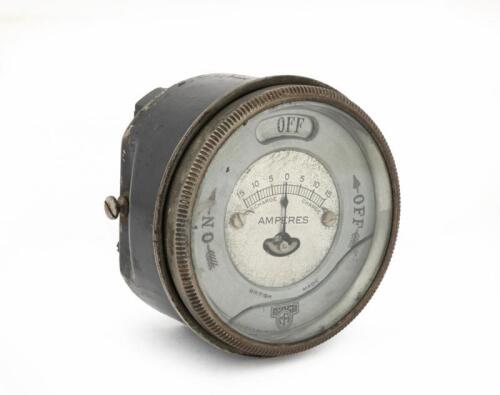 AMMETER: An early Smiths rotary ignition switch and 15-0-15A Ammeter, lens diameter 8cm, gauge plate has a fracture