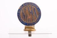 NRMA: A c1927-1929 National Roads & Motorists Association NSW pedestal mounted grille badge numbered to reverse '34061' manufactured by Angus & Coote Sydney, 13cm high overall