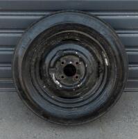 WHEELS: Three early English 14 inch, four stud wheels thought to be from a Morris Minor model, also includes one 15 inch, five stud wheel - 5