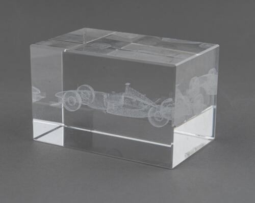 PAPERWEIGHT: A glass paperweight with Formula One car hologram