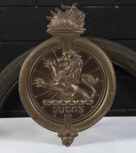 LUCAS: A unusual pressed brass and cardboard 'Lucas' advertising emblem, 34cm high, 23cm wide. Mounting hole to top of torch