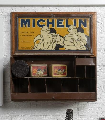 MICHELIN: A c1940s French Michelin 'Paradis' First Aid/Tool tin cabinet with screenprinted advertising to lid featuring wounded Bibendum scene. Display includes three Michelin tins