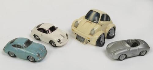 PORSCHE: A group of four interesting Porsche items comprising three small ceramic/clay models of 356's, and one 911 money box