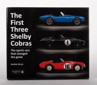 SHELBY COBRA: 'The First Three Shelby Cobras - The Sports Cars That Changed the Game - by Gordon Bruce', hardcover, published 2017, 128 pages