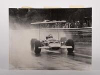 JOCHEN RINDT: A photo of Jochen Rindt driving his Lotus 49B-Ford at Warwick Farm Raceway in 1969, cardboard frame with nameplate is not attached to the photo, would look good mounted & glazed, 30.5cm high, 40.5cm wide