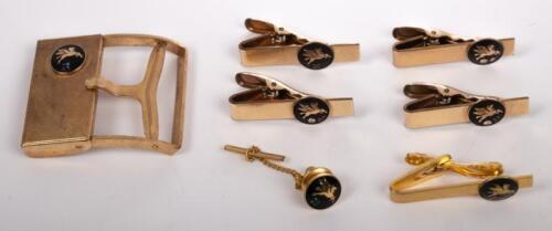 MOBIL: A collection of seven Mobiloil items including five tie pins, a lapel pin and a belt buckle each with inset stones in style of white/colourless diamond, emerald, sapphire and ruby&nbsp;