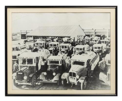 VACUUM OIL: A framed and glazed printed photograph of a Victorian Vacuum Oil Company Depot in the 1930s featuring a&nbsp;fleet of early tankers. 41.5cm high, 51.5cm wide overall.