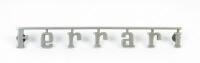 FERRARI: A circa 1960s/1970s early three rear pin Ferrari badge
