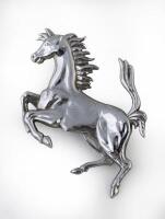 FERRARI: A Ferrari 'Prancing Horse' chromed pressed metal badge, 11cm high
