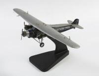 SOUTHERN CROSS: A model of the 'Southern Cross' Fokker Trimotor 'VH-USU' monoplane by Airjet Models Sydney Australia,&nbsp;mounted to display stand, 39cm wingspan