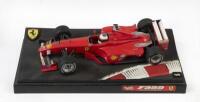 FERRARI F1: A Hot Wheels 1:18 scale 1999 Ferrari F399 with driver Michael Schumacher presented on race track display base