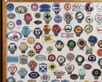 CAR CLUB BADGES: A large collection of approximately 100 car club badges from both Britain, Australia and the USA presented fixed to framed wooden board - 2