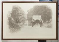 AUSTIN 7: An enlarged black and white photograph of a late 1920s Austin 7 Chummy Tourer driving through a country side scene, framed & glazed 58.5cm high, 84cm wide