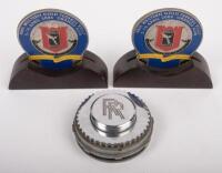 ROLLS ROYCE: Three items relating to Rolls-Royce comprising&nbsp;two Rolls Royce Owners Club of Australia 48th Federal Rally badges on&nbsp;wood bases, and a Rolls-Royce paper weight/desk piece&nbsp;