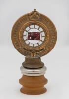 R.A.C.V: An early R.A.C.V. brass with enamel Red Ensign Australian flag & enamel RACV&nbsp;emblem members badge by Stokes & Sons, numbered '346', mounted on wooden base, 19cm high overall