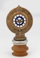 R.A.C.V: An early R.A.C.V. brass with enamel Red Ensign Australian flag & enamel RACV&nbsp;emblem members badge by Stokes & Sons, numbered '346', mounted on wooden base, 19cm high overall - 2
