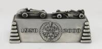 GRAND PRIX: A solid metal desk piece commemorating 50 years of Grand Prix&nbsp;motor racing, 10cm high, 26cm wide