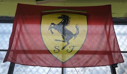FERRARI: A large fabric Ferrari flag with shield form logo to centre, approx 96cm high, 135cm wide