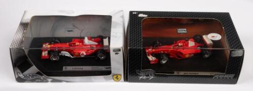 FERRARI MICHAEL SCHUMACHER: Two 1:43 scale Hot Wheels Racing models including a Ferrari F1 2001 and a Ferrari F2004 both driven by Michael Schumacher