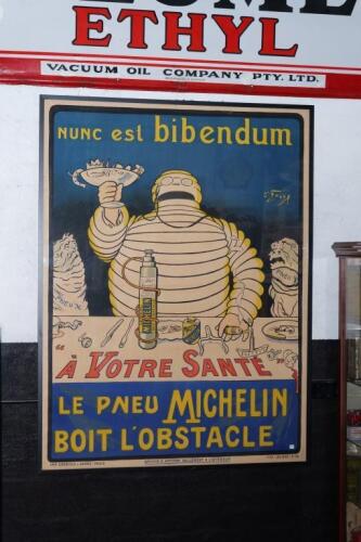 MICHELIN: A large fine reproduction Michelin Advertising Poster 'Nunc est&nbsp;bibendum', 'Le Pneu Michelin', after the first of the Bibendum designs by O Galop (Marius Rossillon), featuring Bibendum&nbsp;about to down a cup of rusty nails and broken bottles, presu