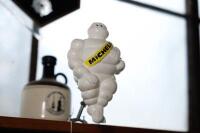 MICHELIN: A modern plastic seated Michelin Bibendum figure with bracket, approx 22cm high