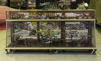 DISPLAY CASE: A large c1930s/1940s nickel plated brass angled glass shop counter display case on iron claw feet, 116cm high, 245cm wide, 60.5cm deep