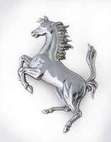 FERRARI: A Ferrari 'Prancing Horse' chromed pressed metal badge, 7.5cm high