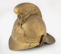 MFB: A modern reproduction MFB 'Metropolitan Fire Brigade' brass helmet by 'The Brass Helmet Co' Size 8, serial no.7434. Approx 25cm high [SALEROOM NOTICE]