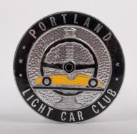 PORTLAND: A Portland light car club grille badge, a very early example of this western district club, an enamel version with the badge having a racing steering&nbsp;wheel, race car and lighthouse on it, circa 1960's, manufactured by K G Luke Melbourne, 7.5cm i