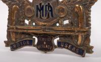 MUA: A pair of motor users association car grille badges, first badge is extremely rare and&nbsp;original but missing the lower section containing the word "association", c1920s, 7.5cm x 16cm, second badge is a brass reproduction version, 8.5cm x 16cm - 2