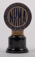 N.R.M.A.: A first style N.R.M.A. car grille badge, a very early copper with vitreous enamel infill, registered number 42193 stamped on the rear, manufactured by Craftsmen enamellers Sydney, 9cm diameter