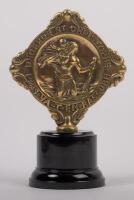 ST. CHRISTOPHER: A 'Regarde St Christophe Puis Va-T-en-Rassure', patron saint of travellers&nbsp;badge, affixed to bakelite base, 11cm high