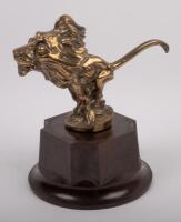 PEUGEOT: A circa 1920s bronze Peugeot lion mascot, engraved 'Baudichon' to lower front, affixed to bakelite base, 12cm high
