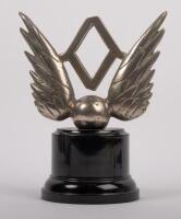 MASCOT: An early nickel plated brass winged mascot with inset central diamond affixed to bakelite&nbsp;base, 9cm high