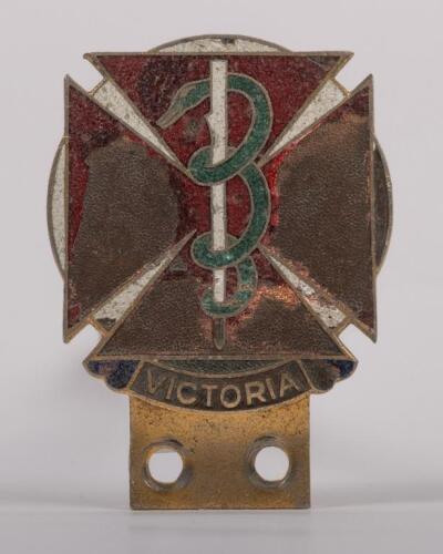 MEDICAL: A circa 1950s Victorian doctors car grille badge enamelled brass, featuring the Rod of Asclepiuson across patt&eacute;e, made by Stokes & Sons of Melbourne, with member number '2558' engraved at rear and further embossed: PROPERTY OF THE MEDICAL SOCIETY